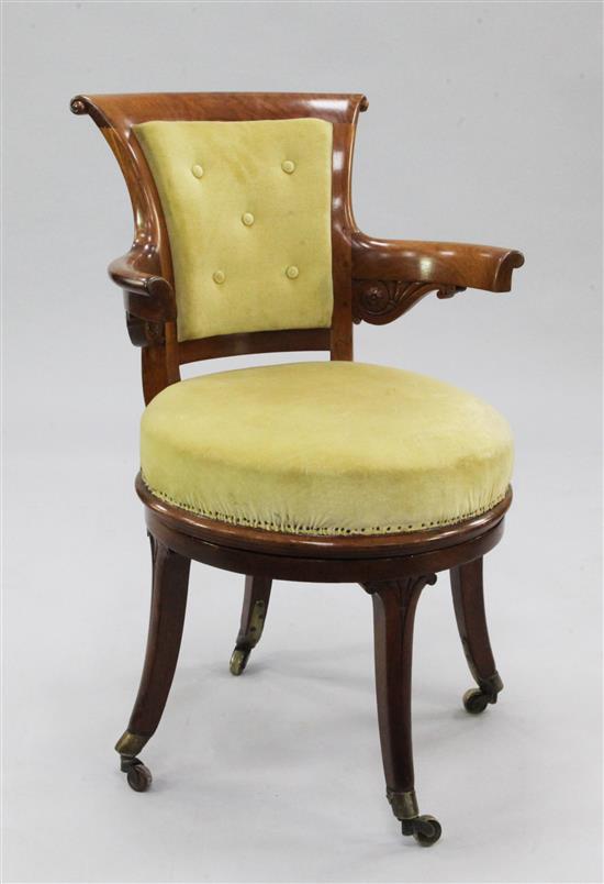 An early 19th century mahogany revolving desk chair,